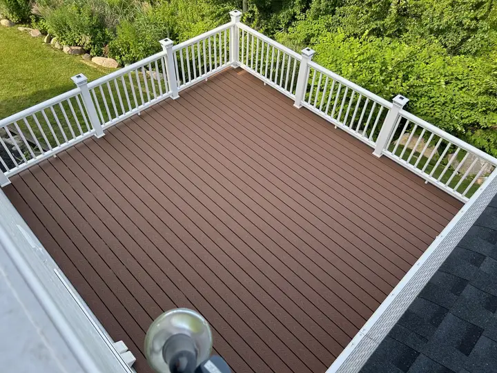 Brown composite deck with white railings, seen from above