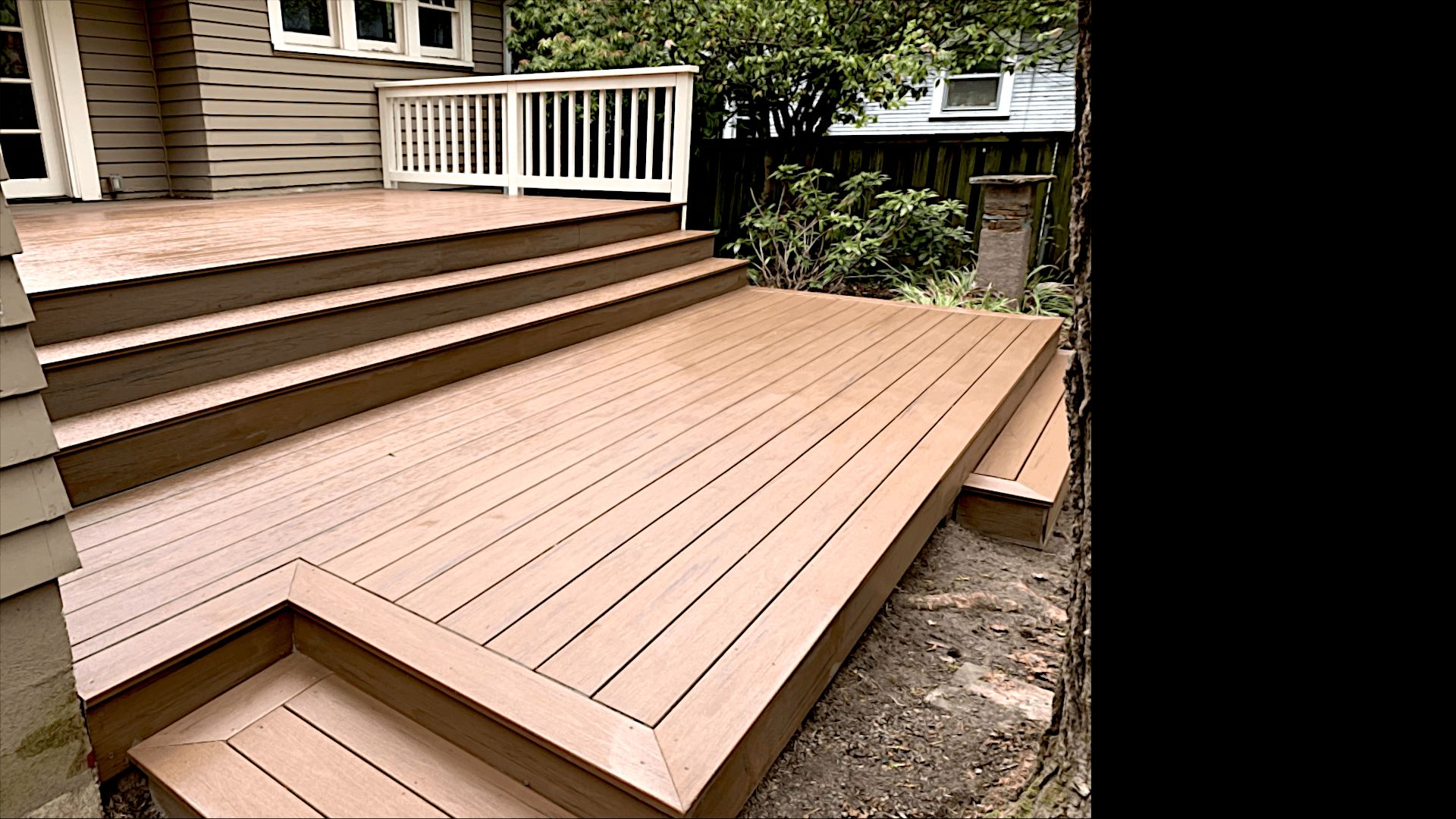 Cedar-toned composite deck with picture-frame edges and wide steps